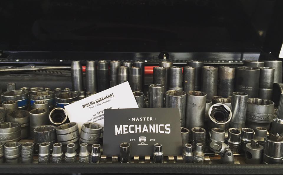 Master Mechanics business cards resting on a socket set in the workshop